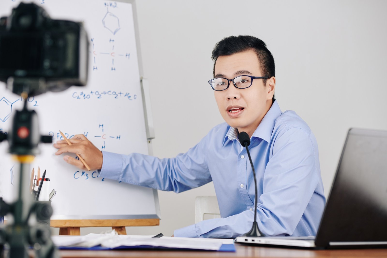 Teacher recording chemistry lesson